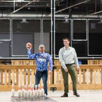 An alumnus about to throw a football at the Fowling Fun Event